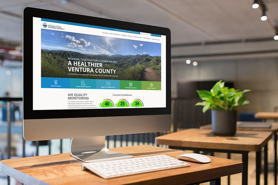A computer screen showcases a website dedicated to Ventura Countys air quality monitoring, beautifully set against an outdoor background that highlights the regions commitment to air pollution control.