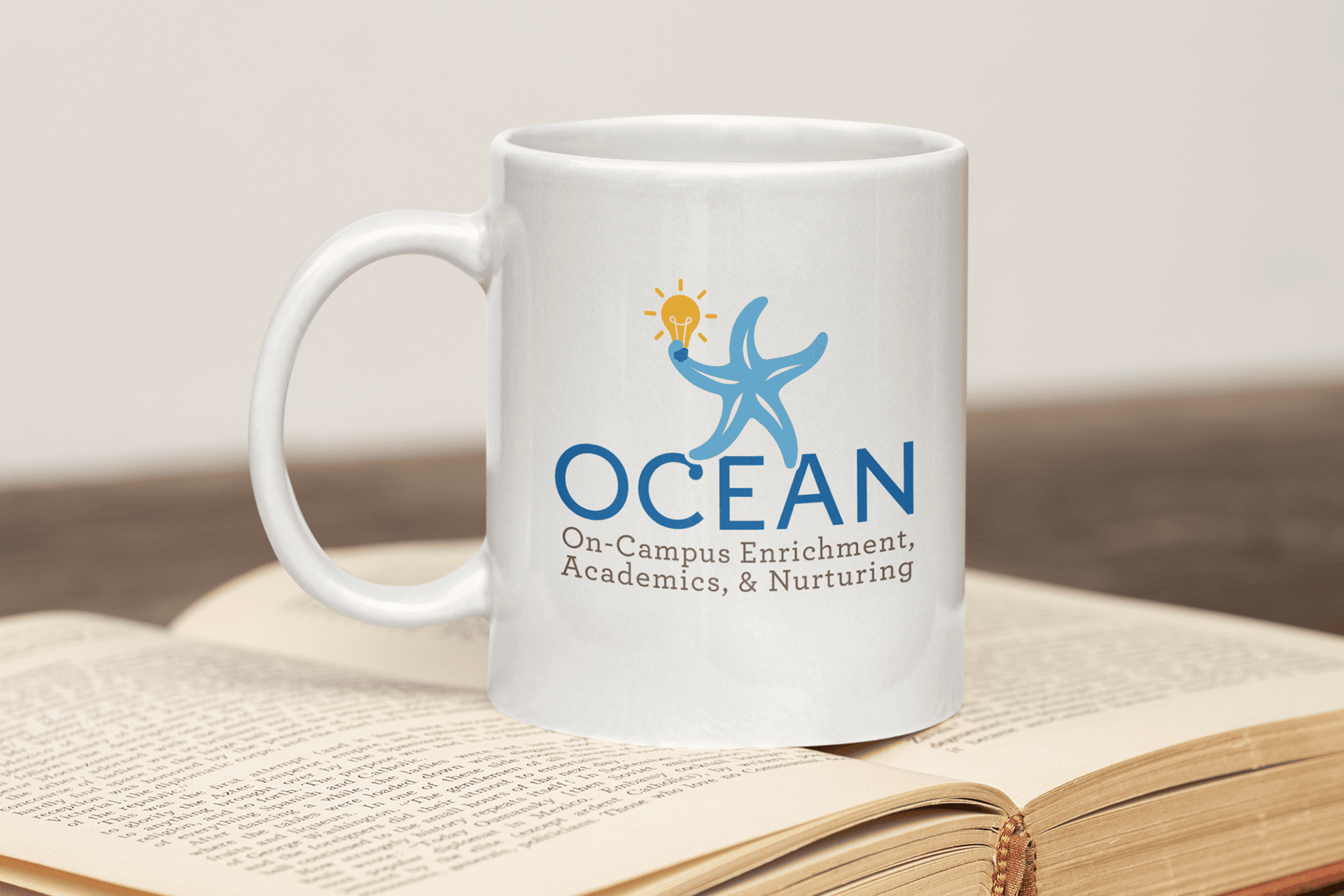Ocean themed coffee mug with starfish logo and enrichment slogan.