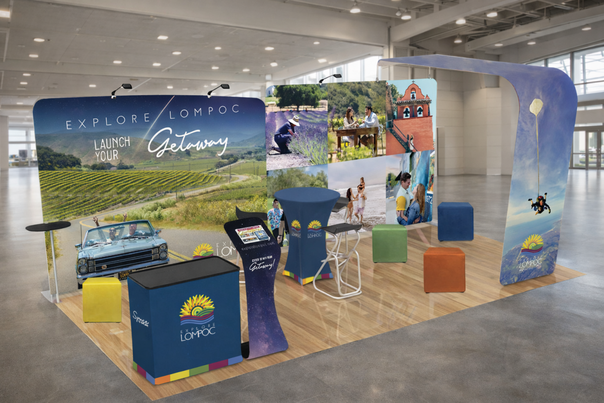 Lompoc tourism booth at an indoor event showcasing local attractions and branding.